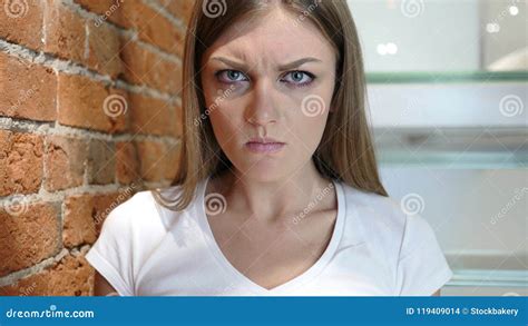 Frustrated Angry Woman Looking At Camera Sitting In Office Stock Photo