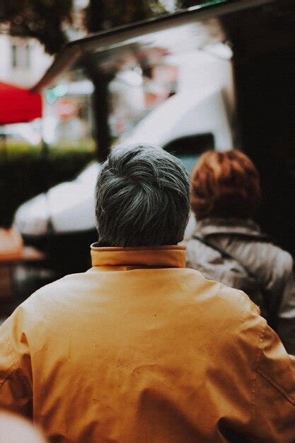 Premium Photo Back View Of A Man Wearing Yellow Jacket Stock Photo