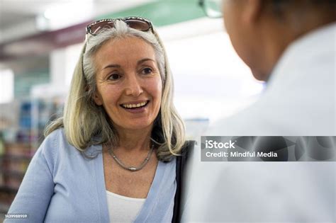 Middleaged Woman Gets Medication Instructions From Local Pharmacist