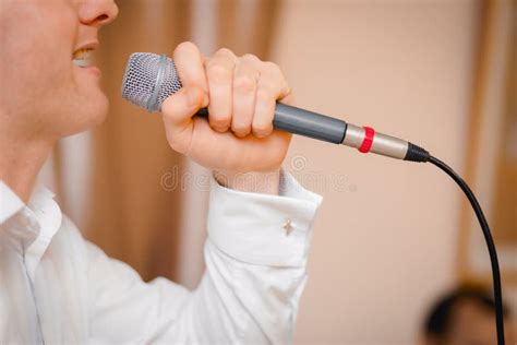 Close Up Guy Singing Into The Microphone Close Up Profile Of