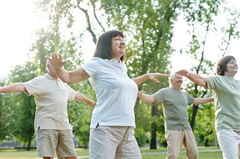 Premium Photo Group Of Mature People Doing Yoga Together During