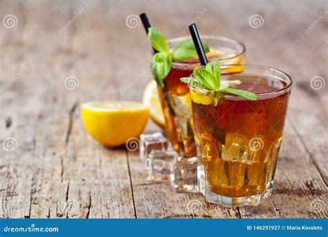 Traditional Iced Tea With Lemon Mint Leaves And Ice Cubes In Two