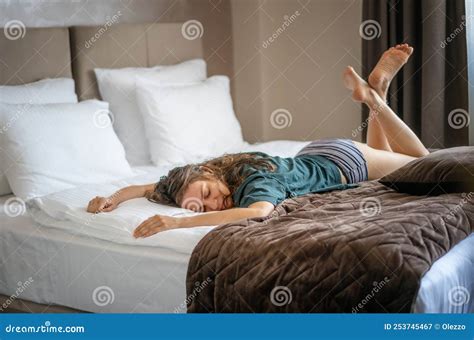 Young Cheerful Woman Lounging On A Comfortable Comfortable Bed Lying On