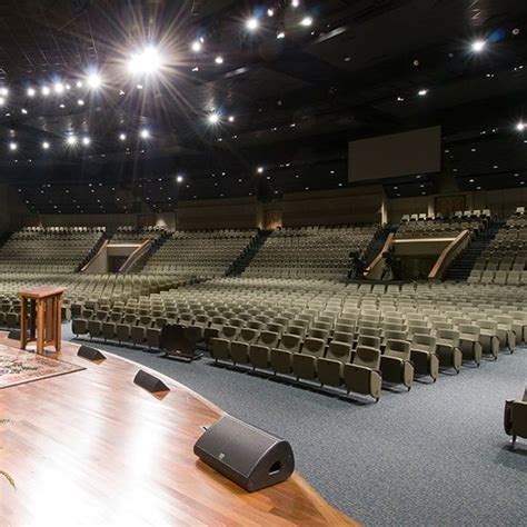 An Empty Auditorium With Rows Of Seats And Speakers On The Floor In