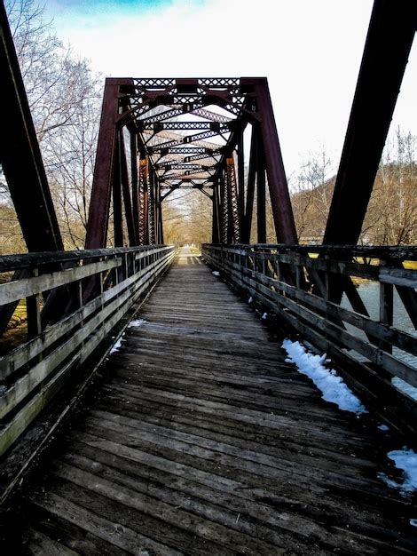 Premium Photo Bridge Over River Against The Sky