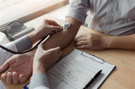 Premium Photo Cropped Hands Of Doctor Examining Patient At Clinic