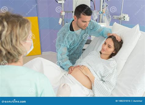 Pregnant Woman Giving Birth in Hospital Stock Photo - Image of midwife ...