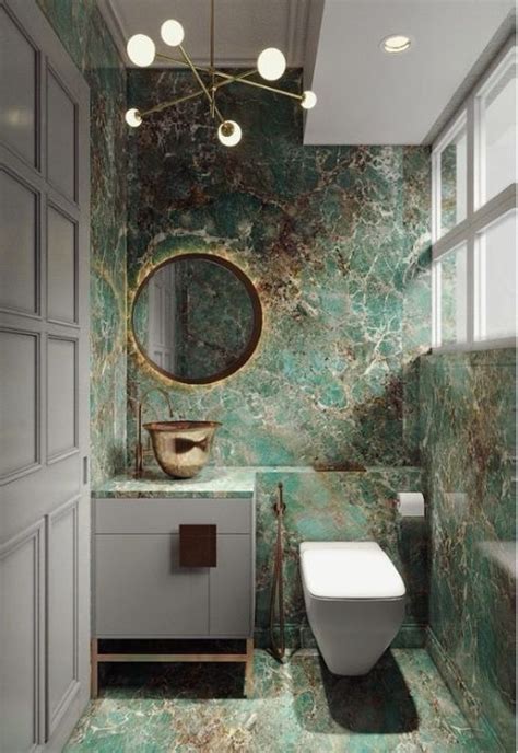 A Bathroom With Green Marble Walls And Flooring Including A White