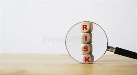 Magnifier Glass With Red Risk Wording On Wooden Block Cubes For Focus