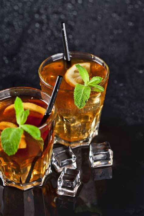 Two Glasses With Cold Traditional Iced Tea With Lemon Mint Leaves And