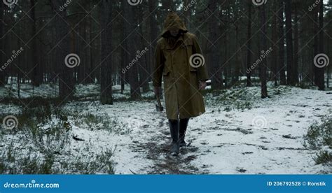 Serial Killer In Brown Hoodie Walking With Axe In Forest Stock Footage