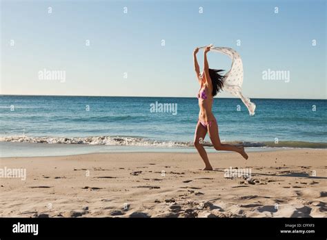 Attractive Woman In Bikini Running With A Sarong Stock Photo Alamy