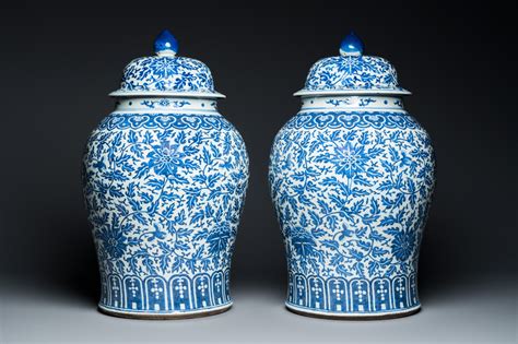 A Pair Of Large Chinese Blue And White Lotus Scroll Vases And Covers