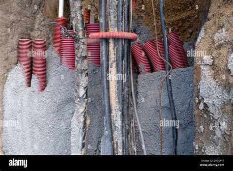 Network Cables In Red Corrugated Pipe Are Buried Underground On The