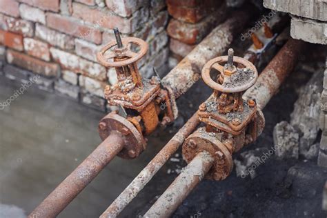 Repair Broken Old Rusty Pipes Of The Heating System Stock Photo