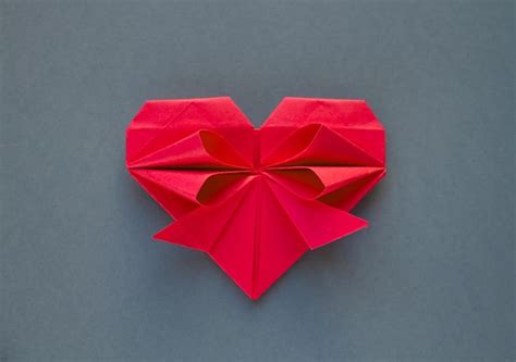 Premium Photo | Red paper heart origami isolated on a grey background