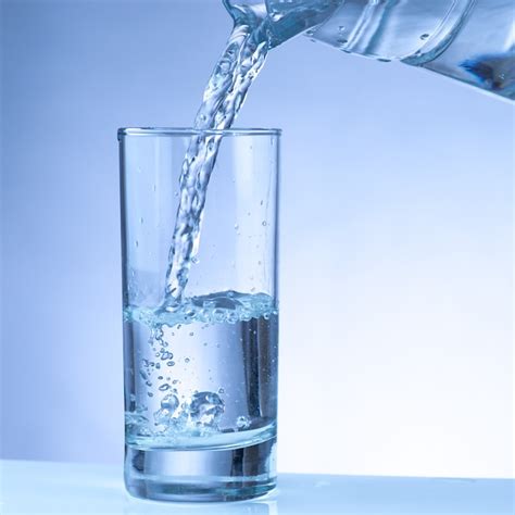 Premium Photo Pouring Water From Pitcher Into A Glass