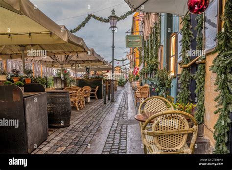 Walk With Colorful Restaurants On The Quayside Of Nyhavn Canal In