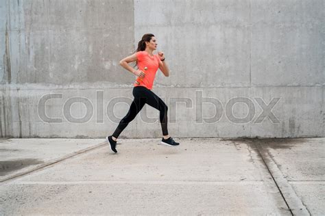 Portrait of a fitness woman running on ... | Stock image | Colourbox