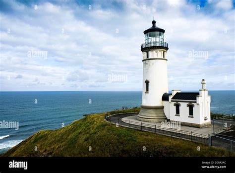 Beautiful old lighthouse, grass, Pacific Ocean and sky, coast of ...