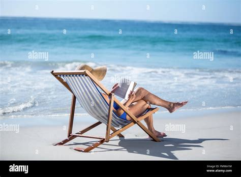 Pretty Mature Woman Reading A Book Lying On Deck Chair Stock Photo Alamy