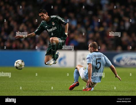 Real Madrid S Angel Di Maria Jumps The Tackle From Manchester City S