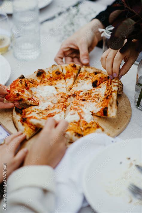 Sharing Pizza With Friends Stock Photo Adobe Stock