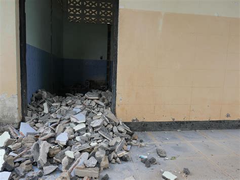 Close-up of the rubble of an industrial building collapsing into a pile