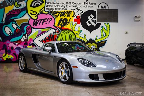 Silver Porsche Carrera Gt In Front Of Wall Of Graffiti Benlevy