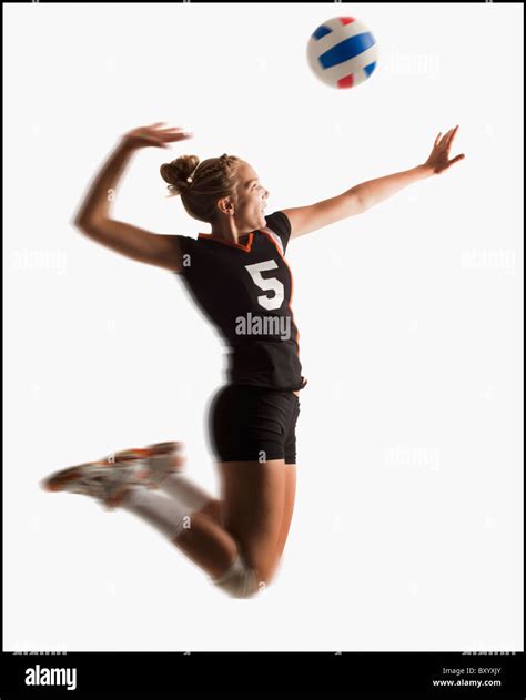 Young girl playing volleyball Stock Photo - Alamy