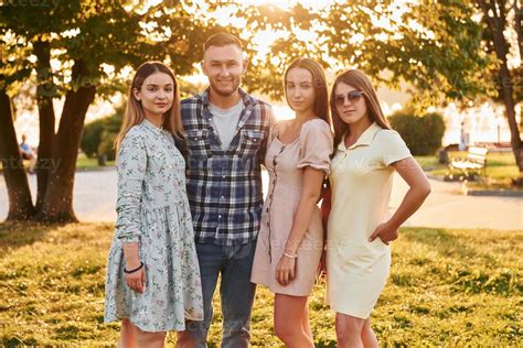 Man With Three Women Standing In The Park And Embracing 15460000 Stock