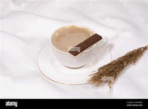 White porcelain cup of coffee with sweet dark chocolate on a flat white ...