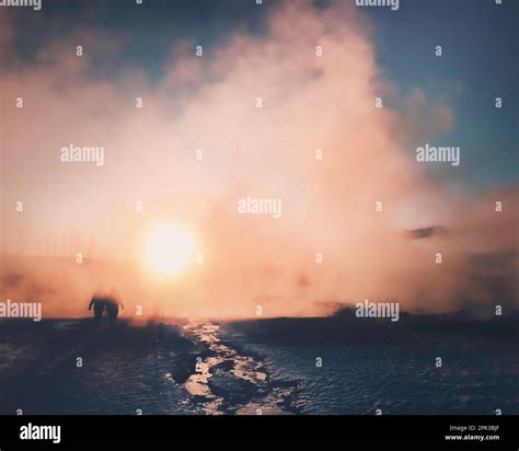 Magical Winter Frozen Geothermal Hot Spring Landscape Mist Steam In Front Of Low Sun At