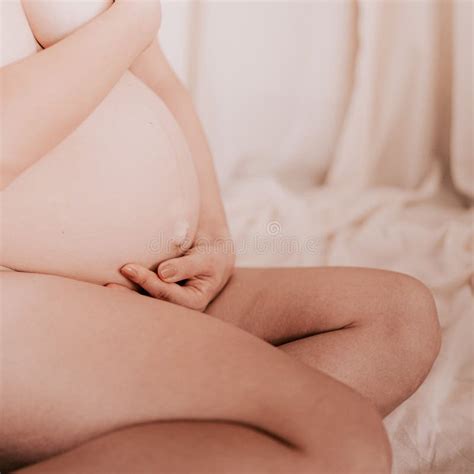 Closeup Shot Of A Nude Pregnant Female Holding Her Belly Stock Image Image Of Cradling Pose