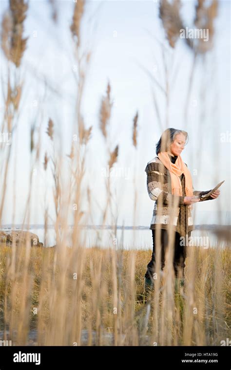 Mature Woman Standing On A Marsh Stock Photo Alamy