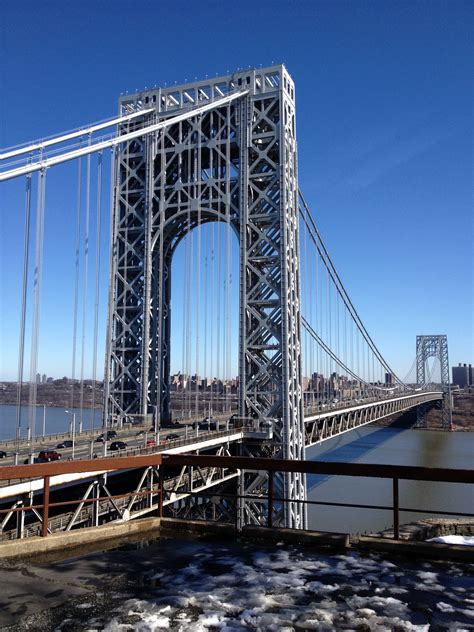 the bridge is very tall and can be seen from across the river