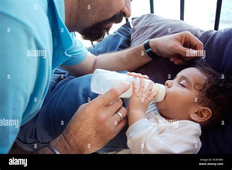 Mature Man Feeding His Baby With A Bottle Stock Photo Alamy