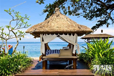 Sunlounger Or Thatch Roofed Deck Chair Beside The Beach Of The Sheraton