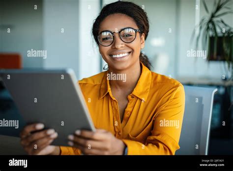 Happy African American Business Lady Using Tablet Pc At Workplace In