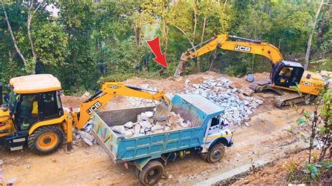 Excavator Loading Stones Into Dump Trucks To Build New Road Excavator