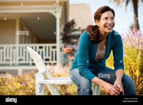 Mature Woman Enjoys Glass Of Red Wine In Her Backyard Stock Photo Alamy