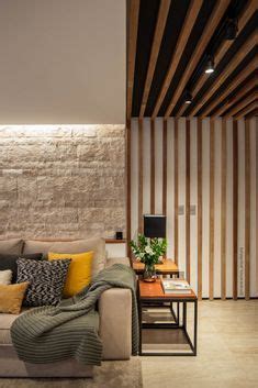 A Living Room Filled With Furniture Next To A Wall Covered In Wood