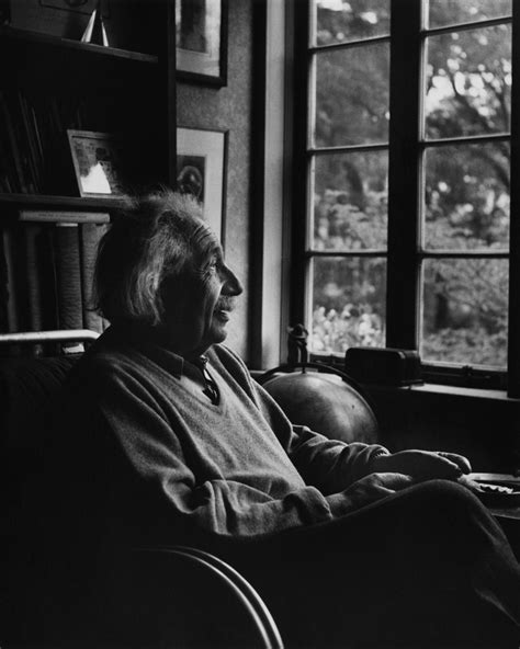 Black And White Photograph Of An Older Man Sitting In A Chair Looking