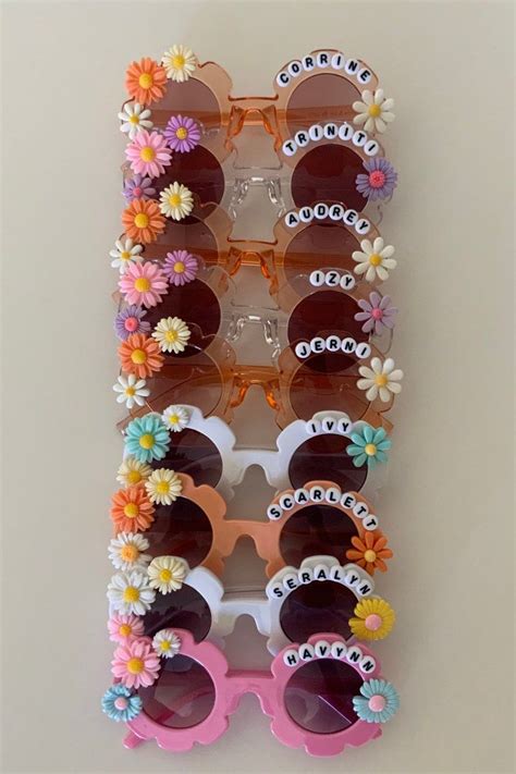 Several Pairs Of Sun Glasses With Flowers On The Frames And Sunglasses