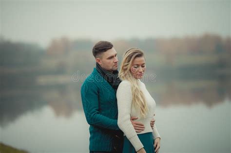 A Heterosexual Couple In Love Hugs And Walk Near The City`s Natural