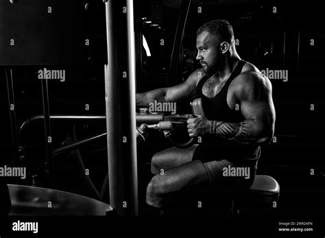 The athlete performs an exercise on the latissimus muscles of the back ...