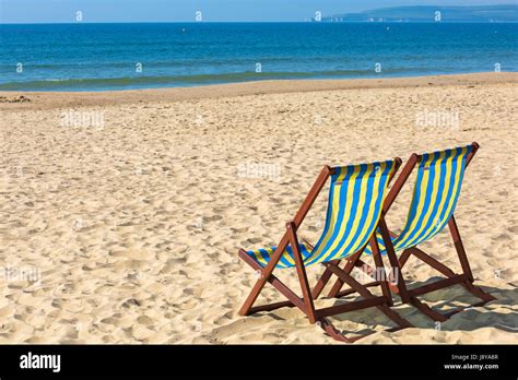 Two Empty Deckchairs On Beach At Bournemouth In May Stock Photo Alamy