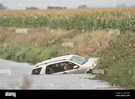 A Vehicle In A Water Filled Ditch Where The Body Of A Man In His