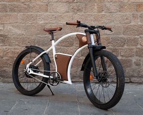 A White And Brown Bicycle Parked Next To A Brick Wall