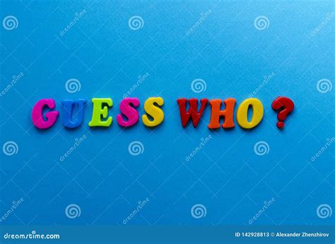 Text Guess Who From Plastic Colored Letters On Blue Paper Background